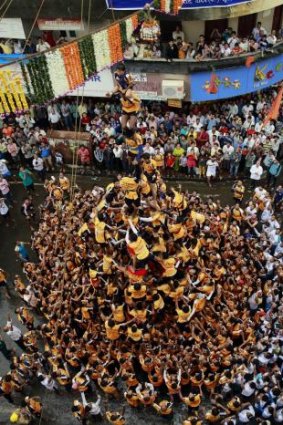 Indian youth form a human pyramid to break the "Dahi handi," an earthen pot filled with curd, a part of the Hindu festival of Dahi Handi. 