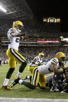 Officials signal after Seattle Seahawks wide receiver Golden Tate pulled in a last-second pass from quarterback Russell Wilson to defeat the Green Bay Packers 14-12 in the NFL.