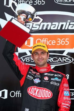Fabian Coulthard holds up his trophy after winning race five of round two.