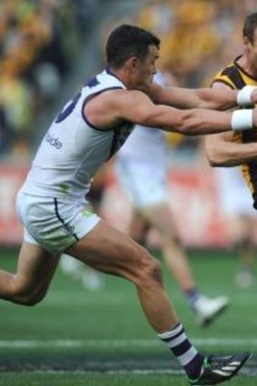Brad Sewell (right) is chased by Ryan Crowley during the 2013 Grand Final against Fremantle.