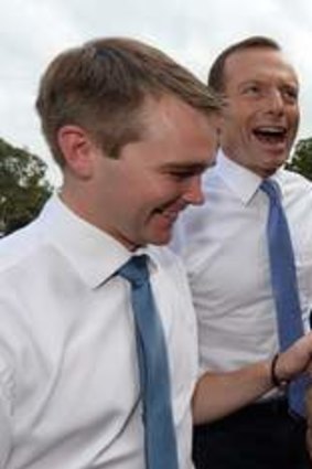 Young ones … Roy and opposition leader Tony Abbott press the baby flesh in Caboolture earlier this month.