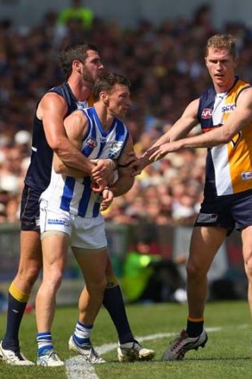 Eagles Jack Darling and Adam Selwood remonstrate with Brent Harvey during the elimination final.