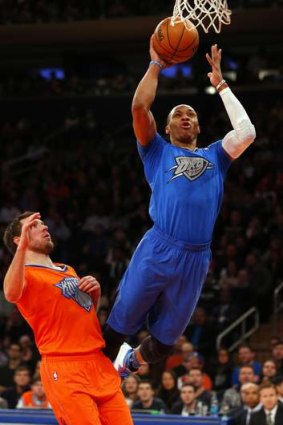 Oklahoma City guard Russell Westbrook takes a shot as Knicks guard Beno Udrih watches him fly by at Madison Square Garden. The Thunder defeated the Knicks 123-94.
