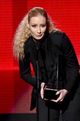 Iggy Azalea accepts the favorite rap/hip-hop album award for <i>The New Classic</i> at the 2014 American Music Awards.