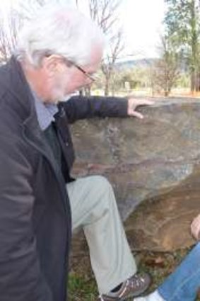 Dr Doug Finlayson and Kirsty Guster of Acton Walkways check out the 2.7 billion year old stromatolite near the National Museum of Australia bus stop