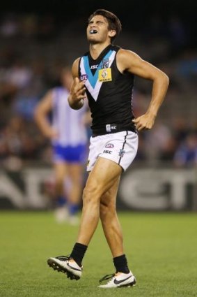 Chad Wingard of the Power limps off in pain during the round three.
