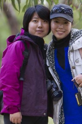 Chinese Tourists Yan Xuan Xia and Sheng Hui from Shanghai enjoy the bushland at a Koala Sanctuary on Phillip Island in Victoria.