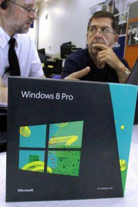 A consultant explains Windows 8 to a potential customer.