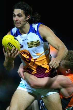 Patrick Karnezis of the Lions is tackled during the game against Greater Western Sydney.
