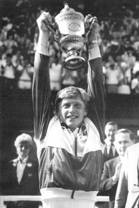Boris Becker holding aloft the winner's  Singles Championship Cup at Wimbledon-1985.