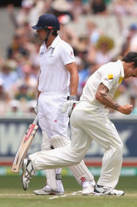 Mitchell Johnson celebrates after taking the wicket of  Alastair Cook.