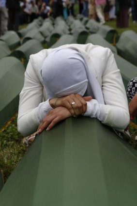 Genocide: A Bosnian Muslim woman cries on a coffin in Srebrenica last Friday as thousands of people gathered for the funeral of 175 victims of Europe's worst massacre since World War II.