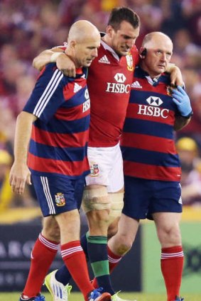 Worrying sight: Lions captain Sam Warburton is assisted from the field with a hamstring injury.