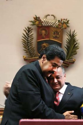 "The struggle goes on": Diosdado Cabello embraces Nicolas Maduro during the swearing in ceremony.