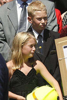 David Balfour's daughter Frances, clutching her firefighter father's helmet, and son Daniel at yesterday's funeral.