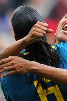 Marta (R) celebrates with the goal scorer Rosana.