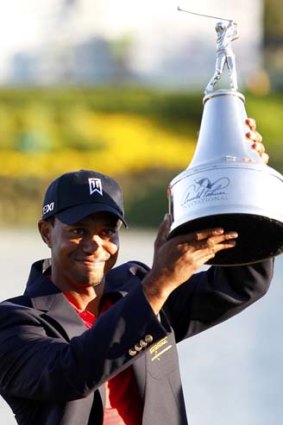 Tiger Woods holds the trophy after winning the Arnold Palmer Invitational.