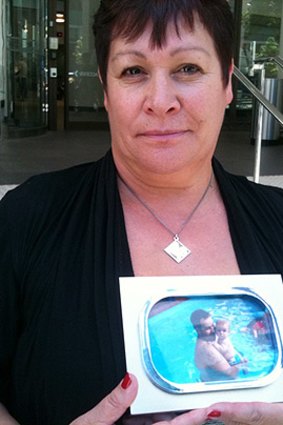 Sharon Russell holds a photo of her son Daniel Williams, who died in a workplace accident at Barrick Gold's Kalgoorlie mine.