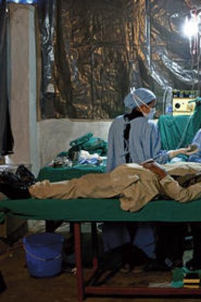 Delicate operation … Ruit works in the temporary operating theatre in a school in Manpur.