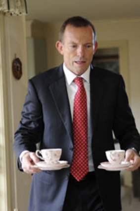 No storm in a cup ... Tony Abbott at a Melbourne couple's home yesterday.
