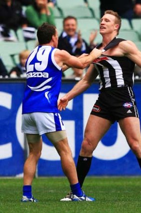 Brent Harvey tries to ruffle Nathan Buckley's feathers.
