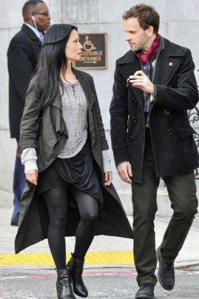 Lucy Lui as Dr Joan Watson and Jonny Lee Miller as Sherlock Holmes on the set of <i>Elementary</i>.