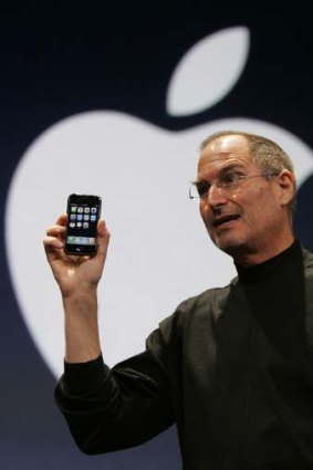 Steve Jobs holds up the first iPhone during his keynote address at MacWorld Conference & Expo in San Francisco in 2007.