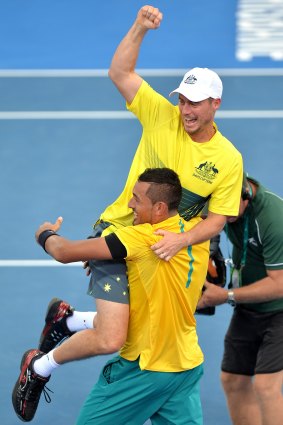 Winning feeling: Nick Kyrgios celebrates with team captain Lleyton Hewitt.