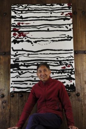 Hou Leong with his work <i>24 Black Horizontal Lines on White</i> at The Silk Road Gallery.