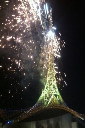 The Arts Centre spire appears to catch on fire as fireworks are shot from the structure.