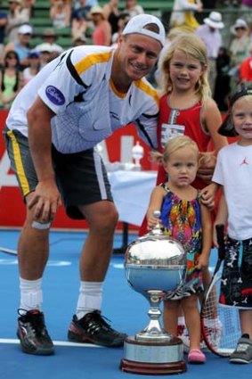 Lleyton Hewiit with his children Mia, Cruz and Ava, after winning the Kooyong Classic in January 2013.