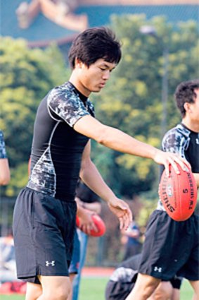 Shanghai Sports University students impressed with their ability to handle the Sherrin during a clinic with Melbourne and Brisbane Lions players.