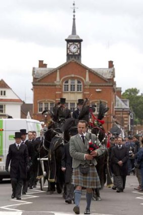 A piper leads the funeral procession of Robin Gibb though the town center of Thame, England.