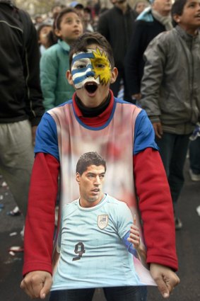 A Uruguay fan exults after the Suarez heroics.