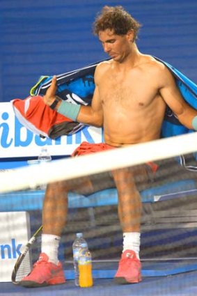 Rafael Nadal sits gingerly during a break between games.