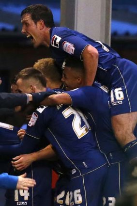 Jubilation ... Oldham Athletic players celebrate after scoring against Liverpool.