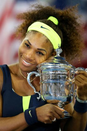 Serena Williams hugs the championship trophy.