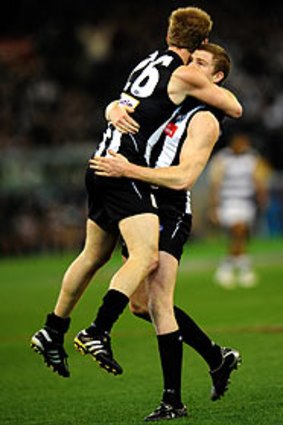 Ben Johnson jumps into the arms of Heath Shaw after a second-quarter goal against Geelong last Friday.