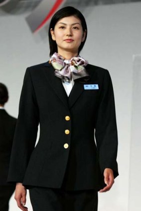 Impeccably groomed and always ready with a smile ... a Japan Airlines flight attendant.