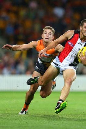 Come here: St Kilda's Nathan Wright dashes clear of Devon Smith at Manuka Oval on Saturday.