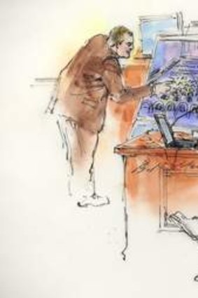 Aurora Police Detective Matthew Ingui is pictured  in a courtroom sketch pointing out victims' locations in the movie theater while testifying in Centennial, Colorado, earlier this year.