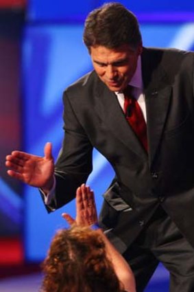 Thrust and Perry: In Tampa, Florida, Republican presidential candidate Rick Perry glad-hands his way through a Tea Party rally.