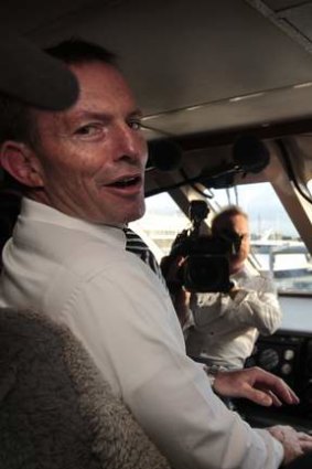 Opposition Leader Tony Abbott sits in the captain's chair aboard a commercial ferry off Green Island during the 2010 election campaign.