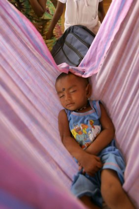 A Tamil child sleeps in a refugee camp in Sri Lanka. The conditions in these camps have been cited as a reason for the exodus of Tamils from the country.