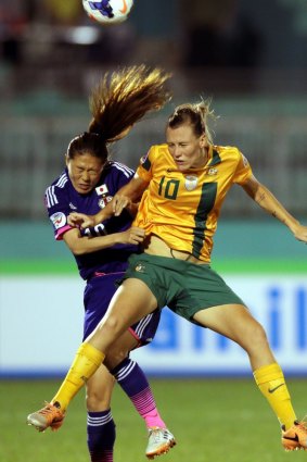 The Matildas' Emily Van Egmond battles Japanese legend Homare Sawa during the Asian Cup final in 2014. 