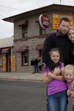 One year on: Publican Josh Nixon, wife Wendy and children outside the dry pub.