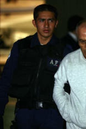 Jean Succar Kuri under police guard in Mexico City in 2006.