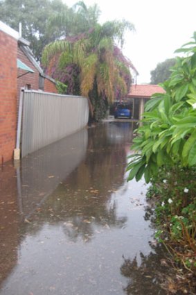 The flooded driveway of a complex in Victoria Park.