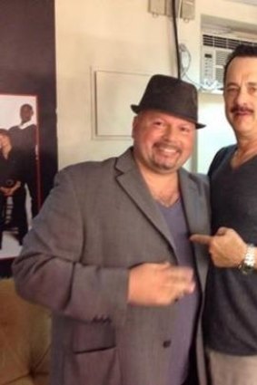 Manny Anzalota posing backstage with Tom Hanks after seeing his show, Lucky Guy. 
