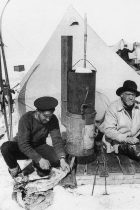 Antarctica ...Photographer Frank Hurley (left) and Sir Ernest Shackleton sit at the entrance to their tent.